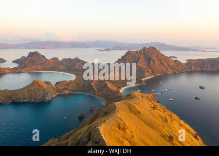 Majestic aerial view using drone the beautiful Padar Island after sunrise with morning light. located in Komodo National Park, East Nusa Tenggara. Stock Photo
