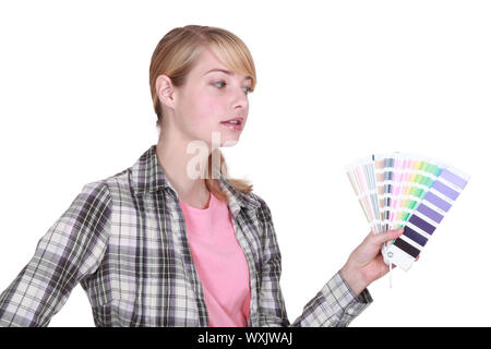 female painter holding colour chart Stock Photo - Alamy