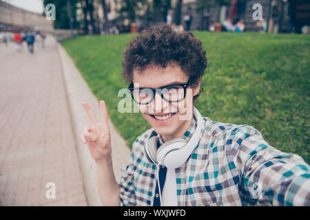 Self-portrait of curly haired cute attractive foolish smiling fu Stock Photo