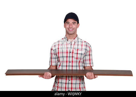 Worker carrying plywood Stock Photo