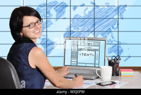 woman sitting in office and web page on screen Stock Photo