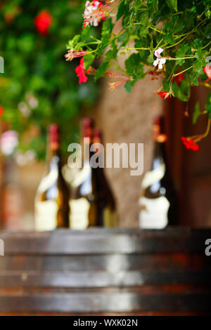 Wine bottles on wodden barrel, winemaking concept Stock Photo