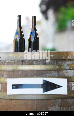 Wine bottles on wodden barrel, winemaking concept Stock Photo