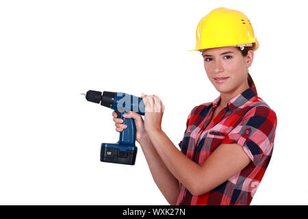 Tradeswoman holding a power tool Stock Photo