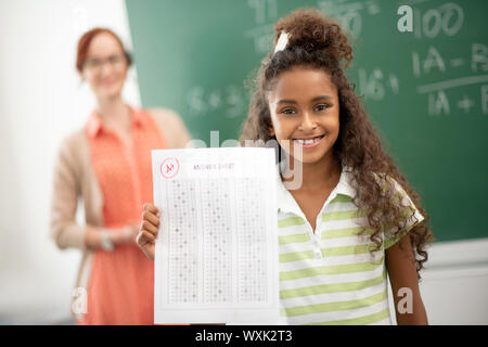 Curly girl feeling amazing after getting good mark Stock Photo
