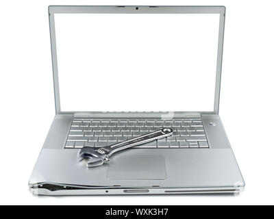 A spanner over a damaged laptop isolated over white background. White copy space on screen. Stock Photo