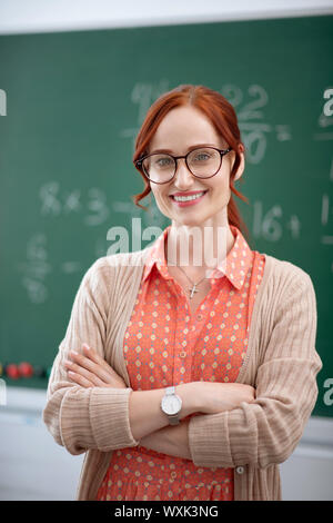 Stylish experienced teacher wearing glasses smiling Stock Photo