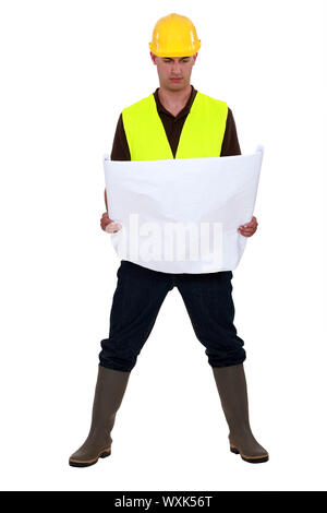 A foreman checking the plans. Stock Photo