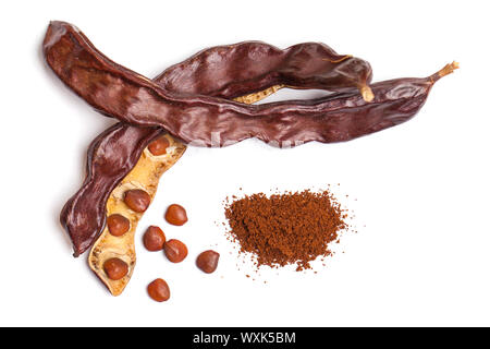 Carob beans with powder. Healthy organic sweet carob pods with seeds on white background. Top view Stock Photo