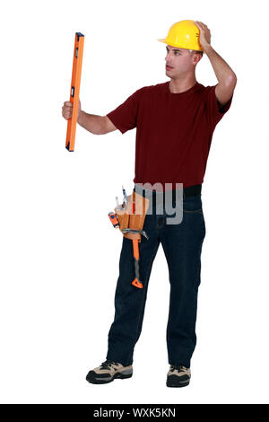 Mason holding spirit level Stock Photo