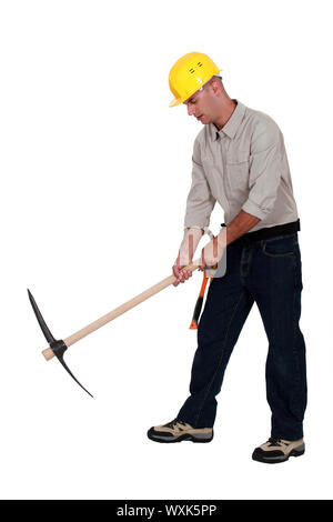 Laborer using a pickaxe Stock Photo