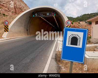 Road sign tunnell near the entrance of the motorway tunnell. Transport infrastructure and safety. Stock Photo
