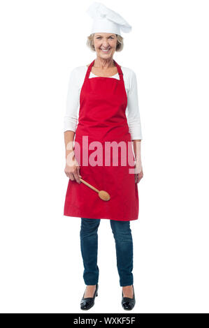 Joyous looking female baker, full length portrait Stock Photo