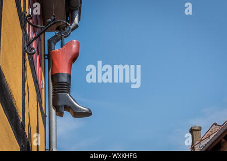 a boot hanging over the street as a symbol of a cobbler in Faaborg, Denmark, July 12, 2019 Stock Photo