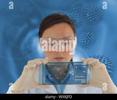 Nurse wearing glasses and holding a virtual screen in front of camera Stock Photo