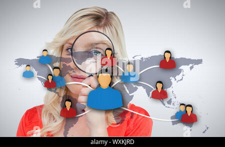 Smiling woman holding magnifier standing in the background Stock Photo