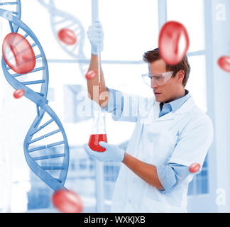 Serious scientist putting chemicals in a testtube in a laboratory Stock Photo