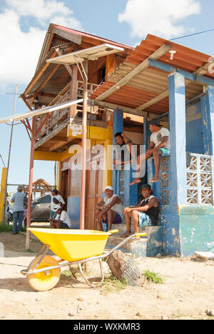Construction workers, builders, resting at the front of a beautiful house in Guna Yala, Kuna Yala, San Blas, Panama. Stock Photo