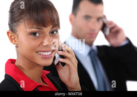 Businesspeople using cellphones Stock Photo