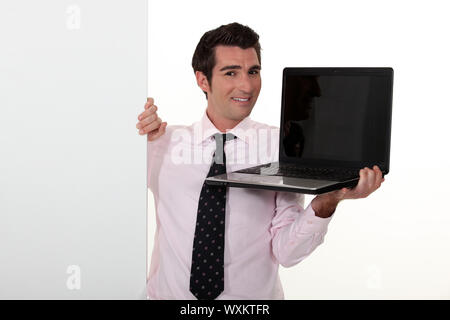 Man in smart suit showing notebook Stock Photo