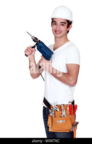 Young tradesman holding an electric screwdriver Stock Photo