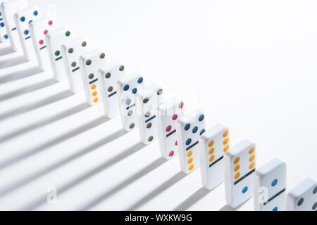 Line of colourful dominoes stacked neatly with shadows Stock Photo