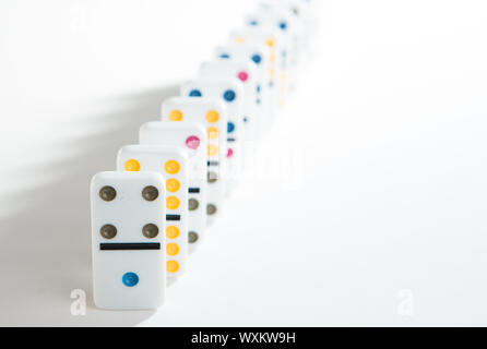 Line of colourful dominoes on white background with shadows Stock Photo