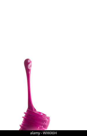 Spilled pink nail polish against a white background Stock Photo
