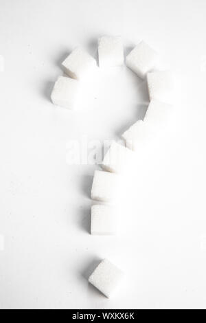Sugar cubes in shape of question mark against a white background Stock Photo