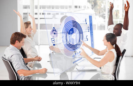 Cheerful business workers using blue diagram interface in a meeting Stock Photo