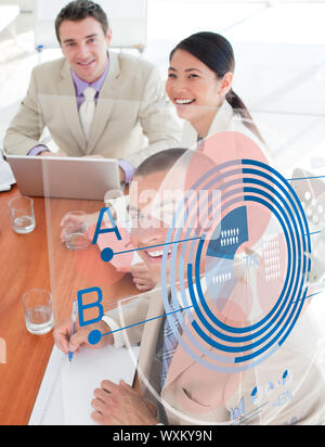 Overview of cheerful colleagues looking at blue chart interface in a meeting Stock Photo