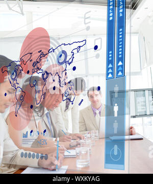 Serious business people using blue map interface in a meeting Stock Photo