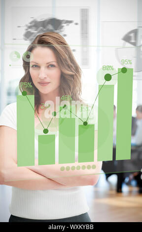 Confident blonde businesswoman using green chart interface with statistics Stock Photo