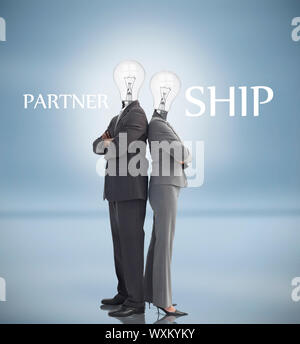 Business people with light bulbs instead of heads and partnership text posing against blue background Stock Photo