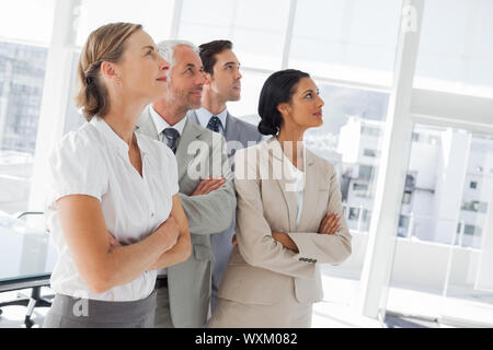 Confident business people looking at the same way in the workplace Stock Photo