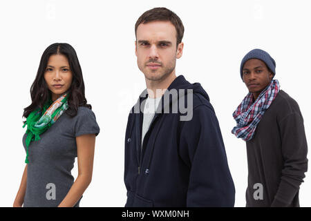 Serious stylish young people in a line on white background Stock Photo