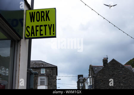 Writing note showing Work Safety. Business concept for policies and procedures in place to ensure health of employees Green ad board on the street wit Stock Photo