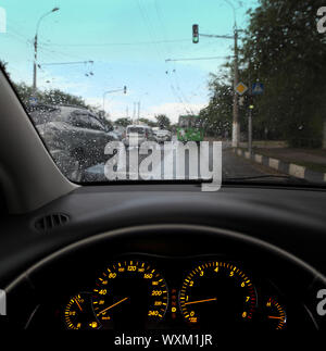 rain droplets on car windshield, traffic in city Stock Photo