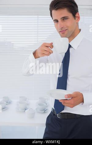 Handsome businessman having a coffee during the break Stock Photo