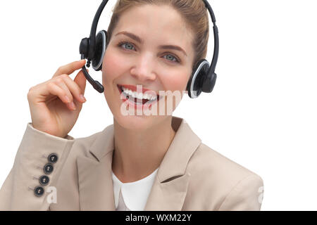 Laughing operator talking on headset looking at the camera Stock Photo