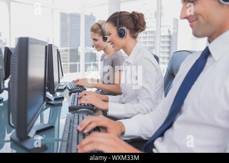Call centre employees at work on computer in office Stock Photo