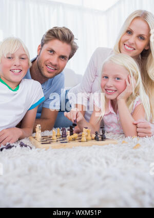 Family playing chess in the living room Stock Photo