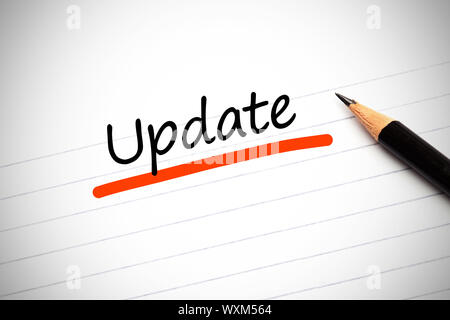 Update written on a notepad with a pencil and underlined in orange Stock Photo