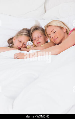 Blonde woman sleeping in bed with her children Stock Photo