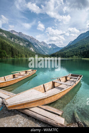 Scenic mountain landscape with turquoise lake and wooden boat at sunny summer day in Austria Alps Stock Photo