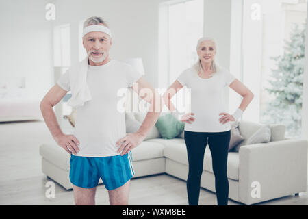 Two adorable healthy charming stylish old people doing physical Stock Photo