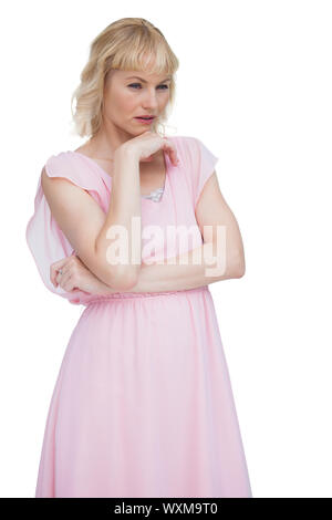 Classy blonde thinking against white background Stock Photo