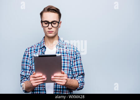 Portrait of concentrated teen, teenager in blue checkered shirt Stock Photo