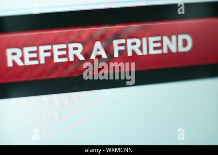 Close up Red button refer a friend on a  white background. Stock Photo