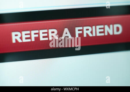Close up Red button refer a friend on a  white background. Stock Photo